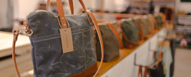 Line of waxed canvas bags on display