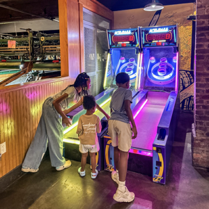 Kids playing skee ball at Ruby's Arcade