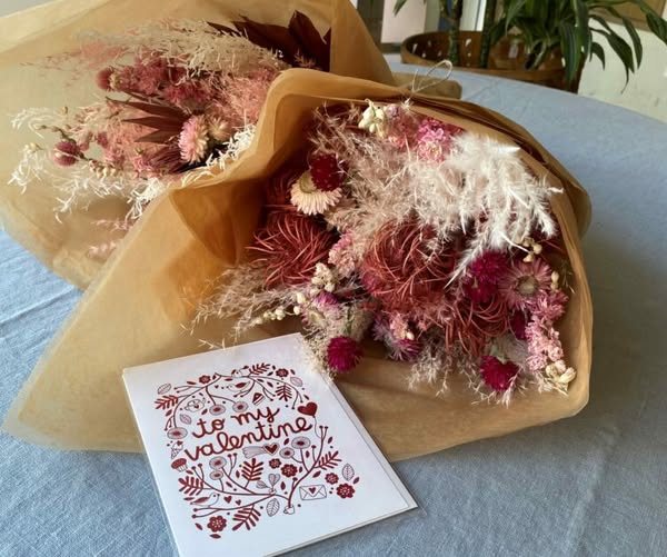 Bouquet of pink flowers with a Valentine's Day card