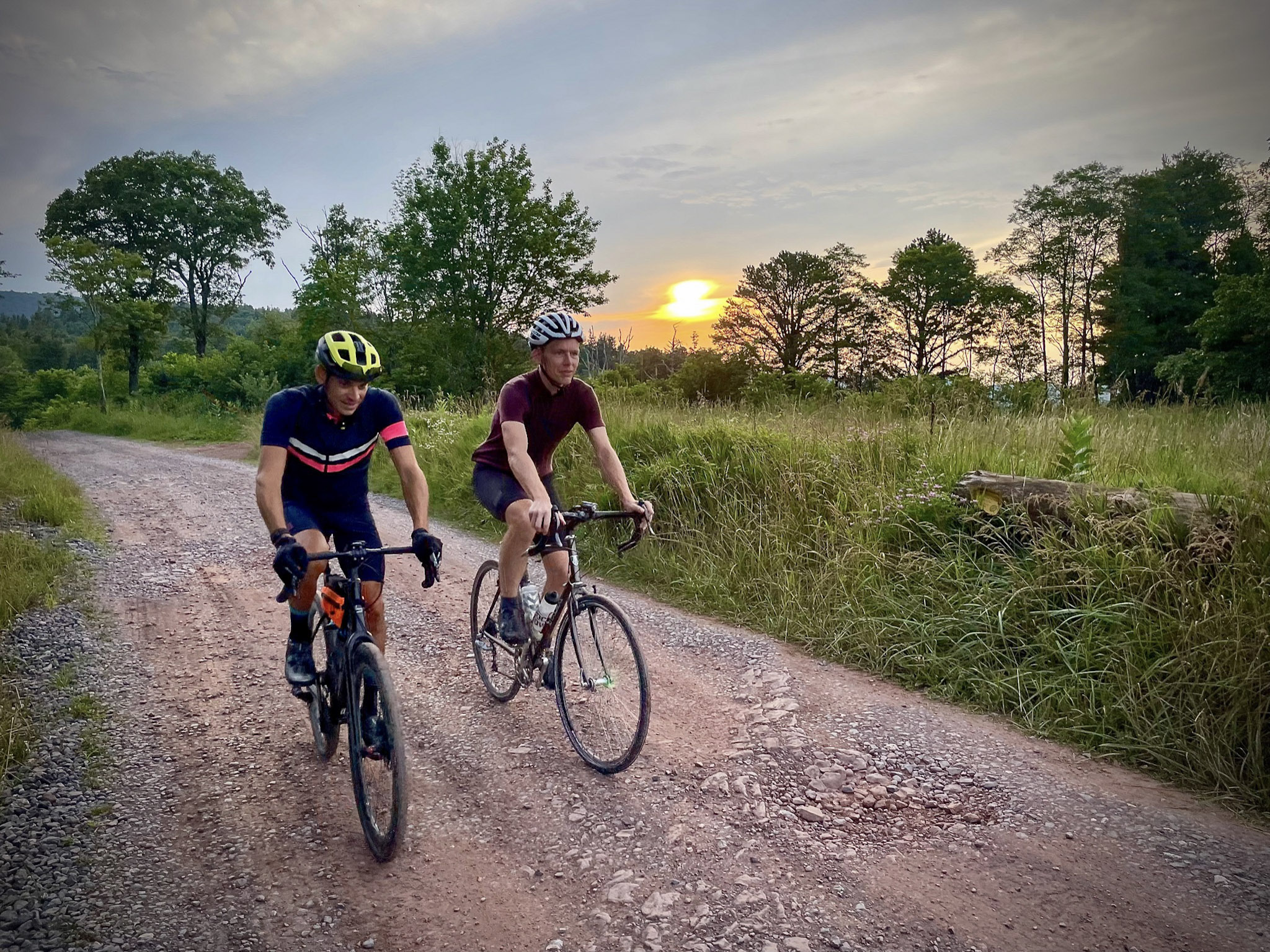 Cyclists on trail at sunrise