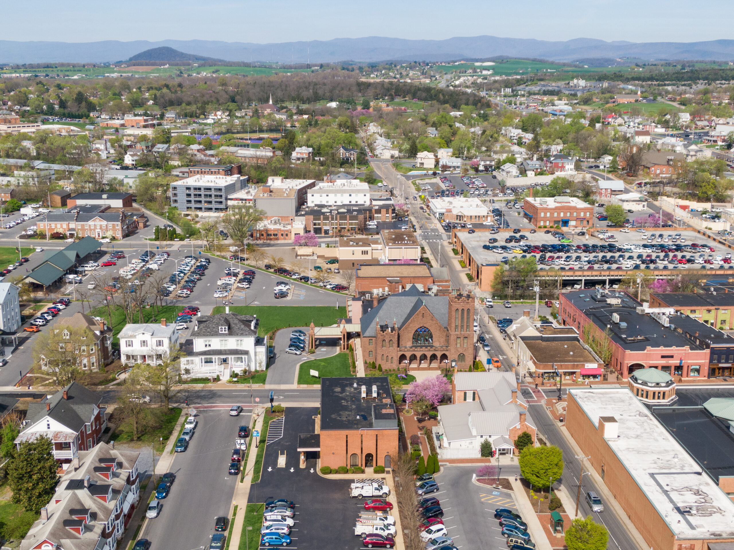 Drone shot of downtown Harrisonburg with the mountains in the background