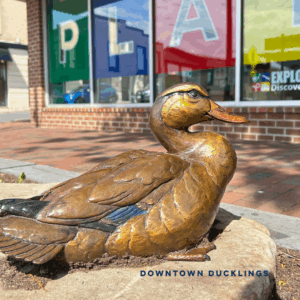 Bronze duck statue outside of Explore More Museum.