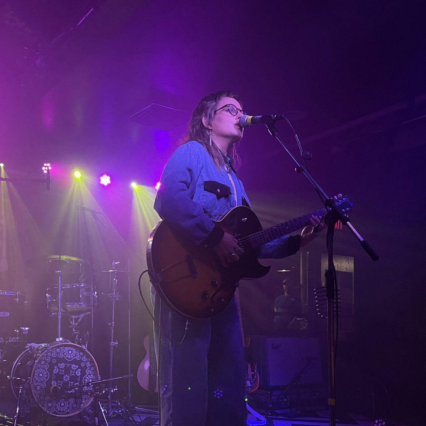 Person singing and playing guitar