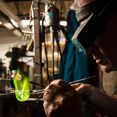 person making jewelry