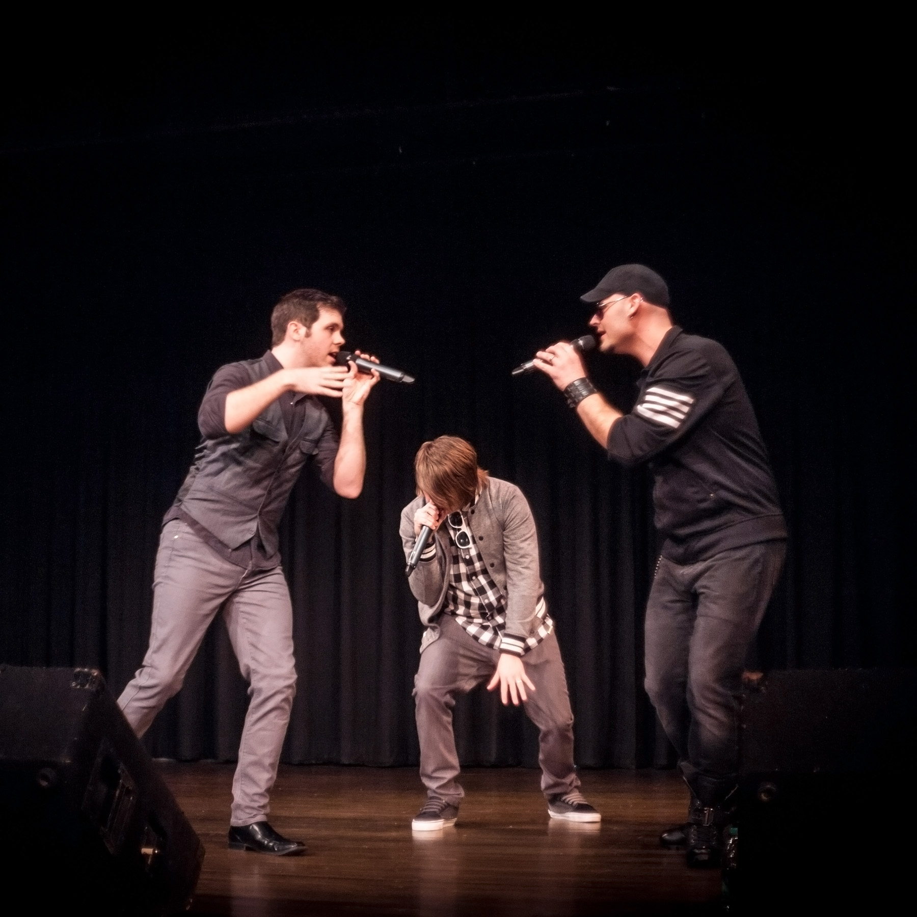 People singing into microphones