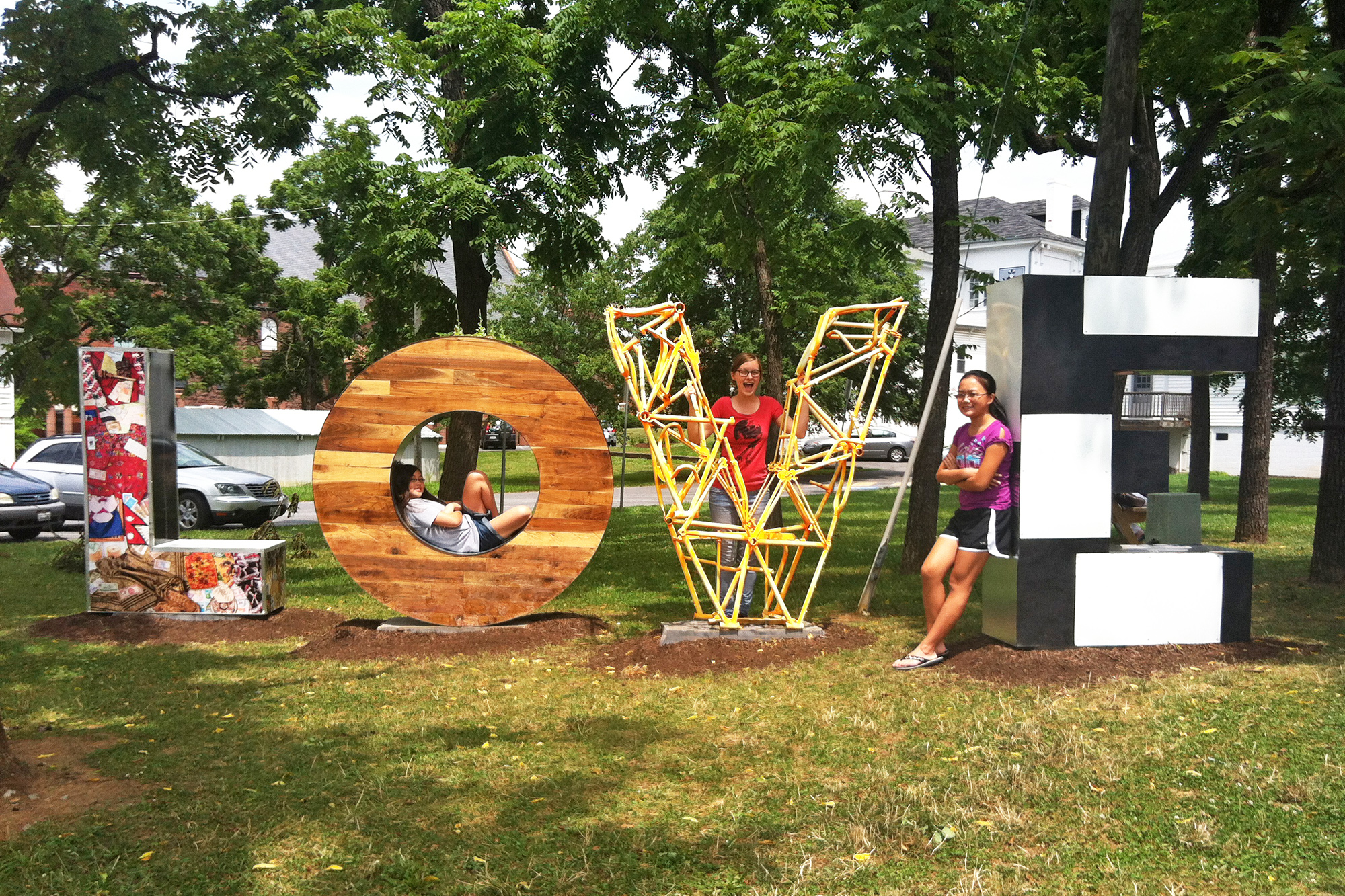 Girls on LOVE statue posing for a picture