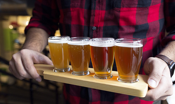 Someone holding a beer flight