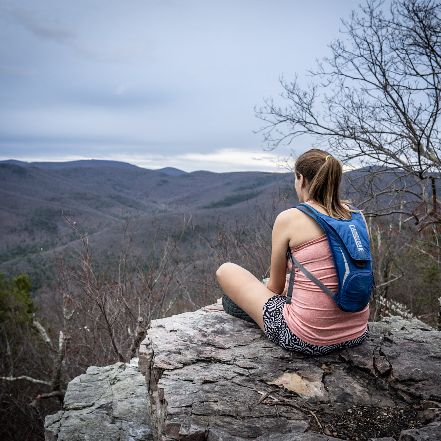Woman sitting on rocks