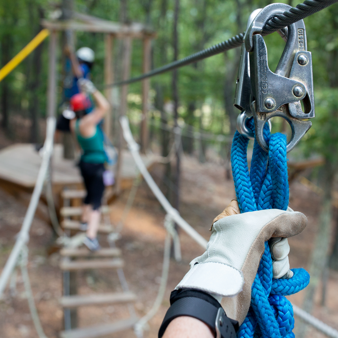 Ropes Course in Harrisonburg Person holding onto ropes on a ropes course in Harrisonburg