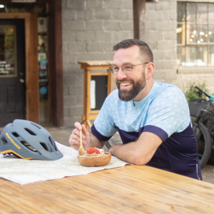 Man eating an acai bowl after biking