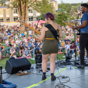 Two musicians performing in front of crowd