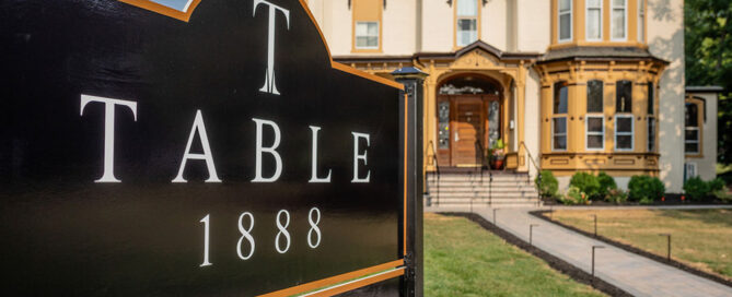 Table 1888 Sign with building in the background