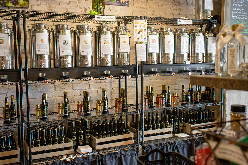 Containers of olive oil on shelves